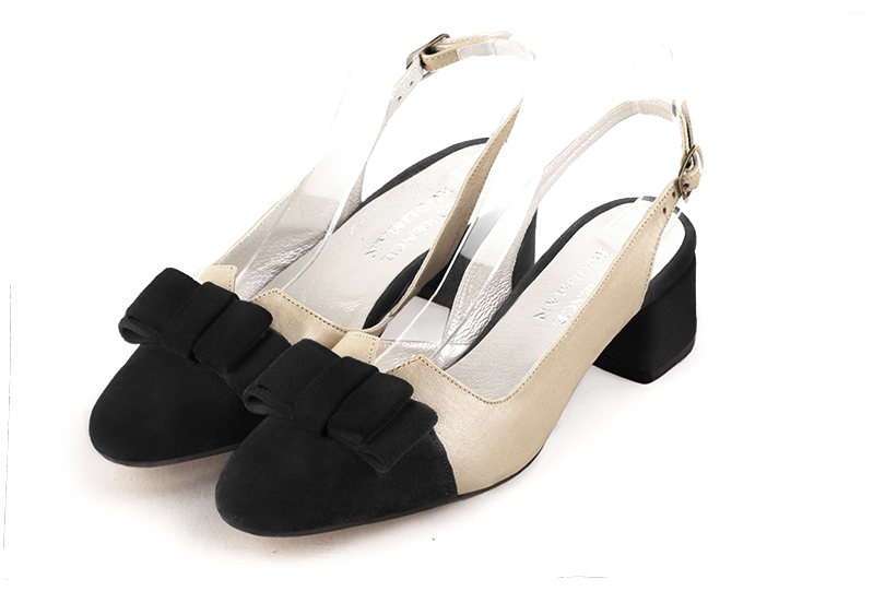 Matt black and gold women's open back shoes, with a knot. Round toe. Low flare heels. Front view - Florence KOOIJMAN